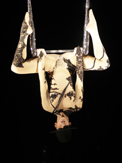 Beautiful artist performs the high art of aerial artistry on the chandelier a harmonious powerful acrobatics choreographed to modern and exciting music.