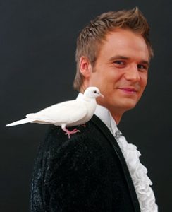 Magician conjures up doves, rabbits and his little dog