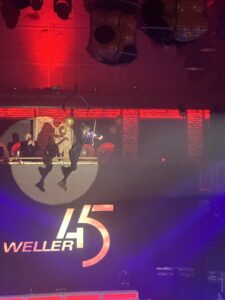 "Flying Violin" performer on a rotating platform during an event opening