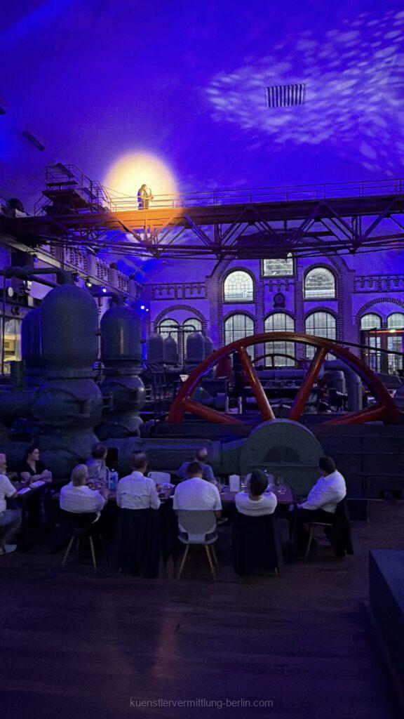 A "flying" saxophonist hovers 15 meters above the guests at the Wasserwerk Berlin during a corporate event.