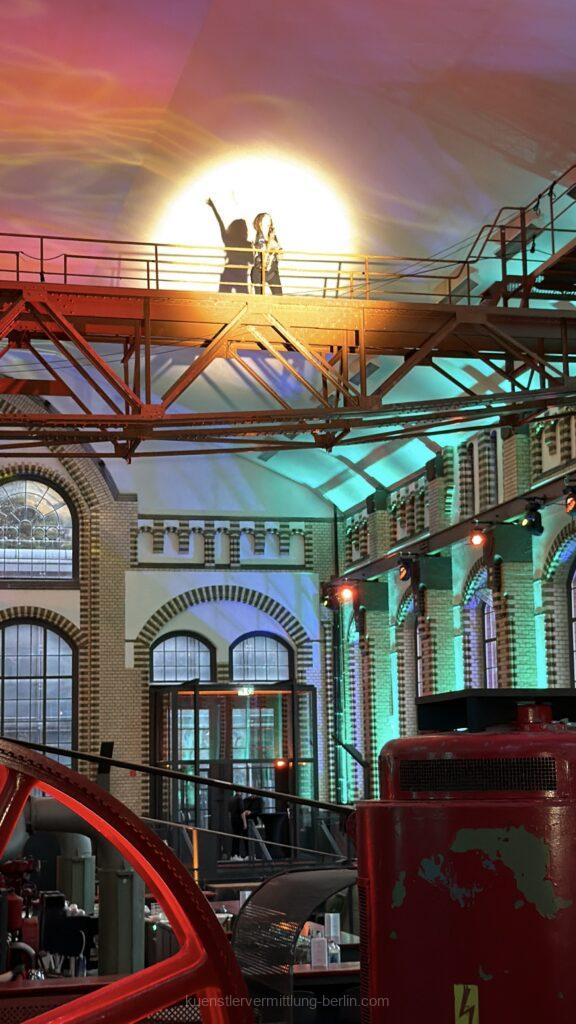 A flying saxophonist plays live music above the heads of the guests at Wasserwerk Berlin.