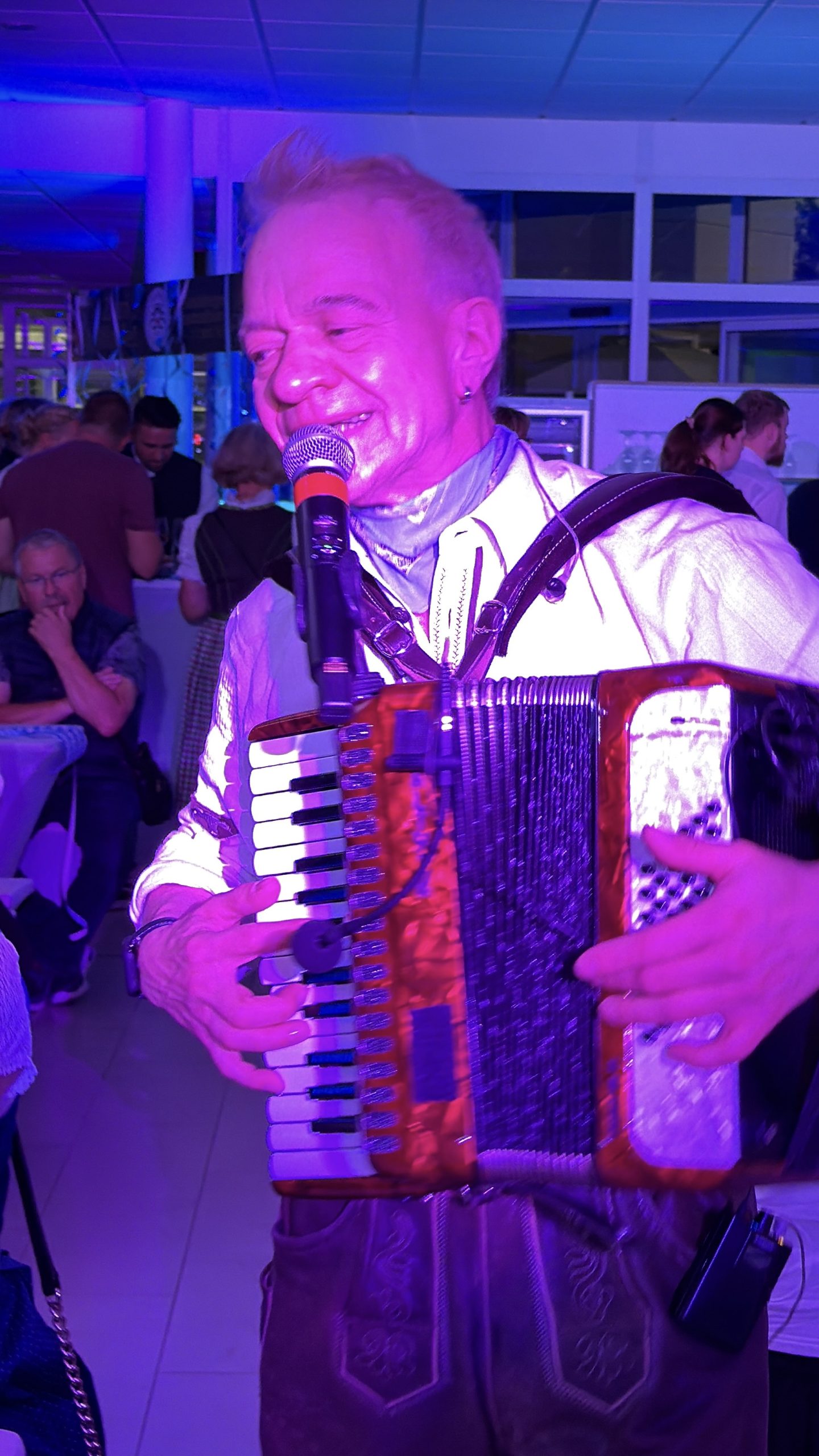 Accordion players from the Oktoberfest party band mingling with the guests